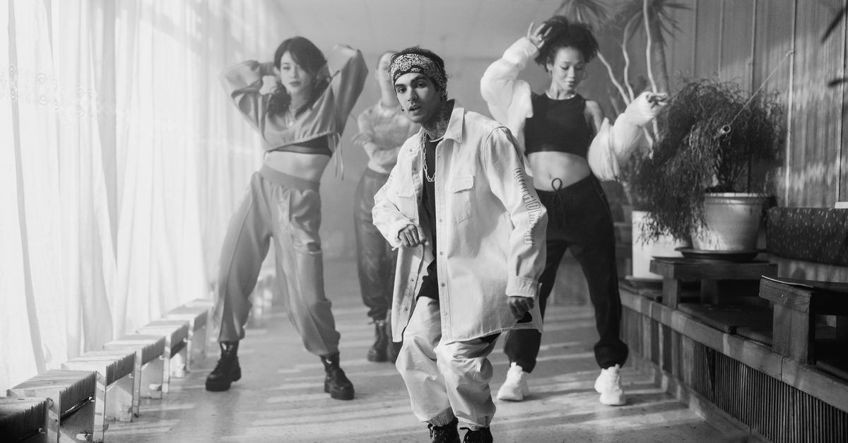 Energetic group of dancers performing hip hop in a stylish indoor setting.
